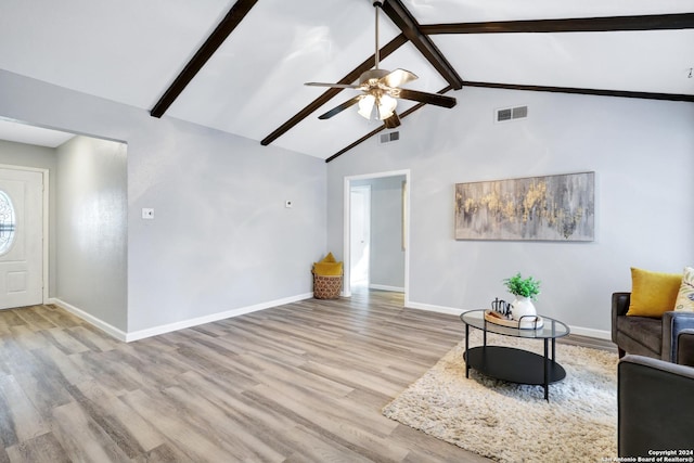 unfurnished living room with beam ceiling, light hardwood / wood-style floors, high vaulted ceiling, and ceiling fan