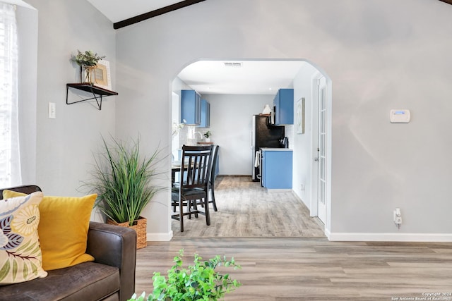 interior space with light hardwood / wood-style floors and lofted ceiling