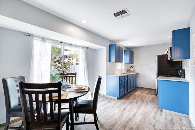 dining space featuring sink and light hardwood / wood-style flooring