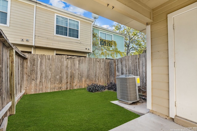 view of yard featuring central air condition unit