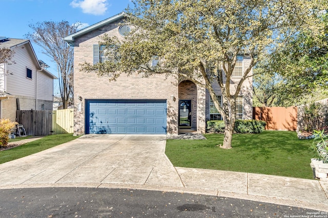 view of front of property with a garage and a front lawn