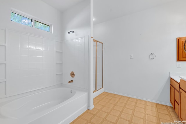 bathroom with vanity and independent shower and bath