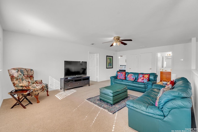 carpeted living room featuring ceiling fan