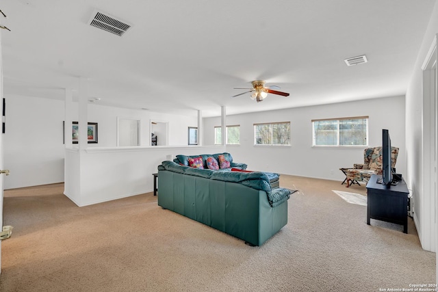 living room with light carpet and ceiling fan