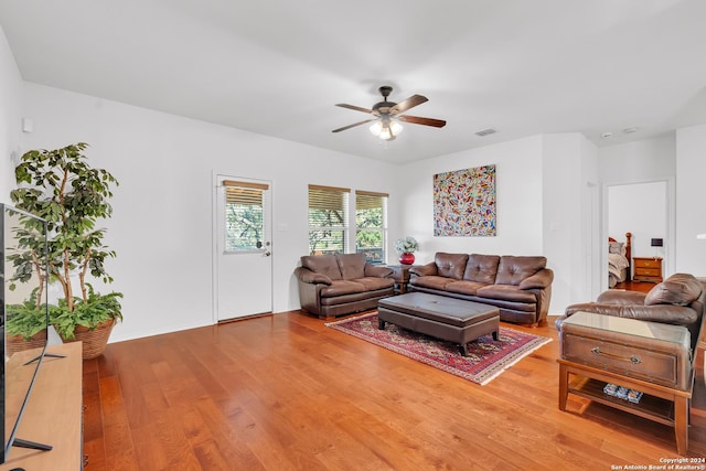 living room with hardwood / wood-style flooring and ceiling fan