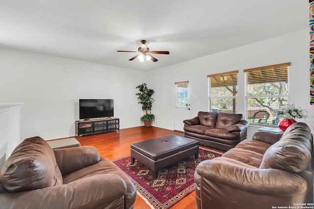 living room featuring ceiling fan and hardwood / wood-style floors