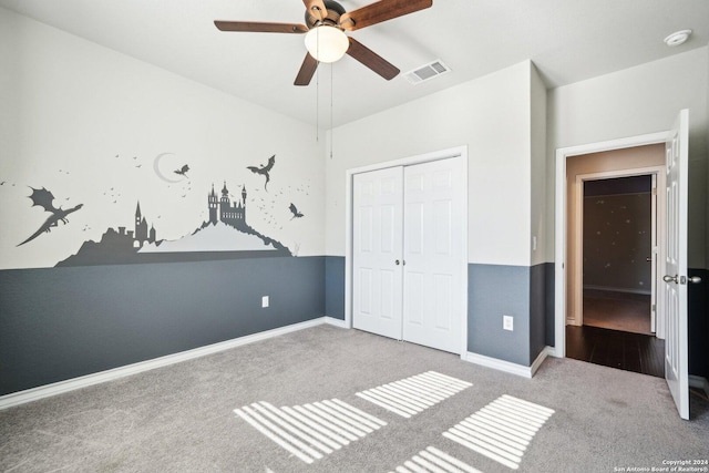 unfurnished bedroom featuring light carpet, a closet, and ceiling fan