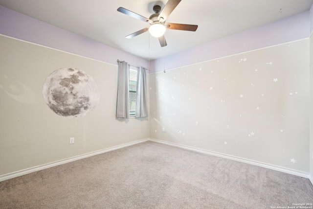 unfurnished room with ceiling fan and carpet floors