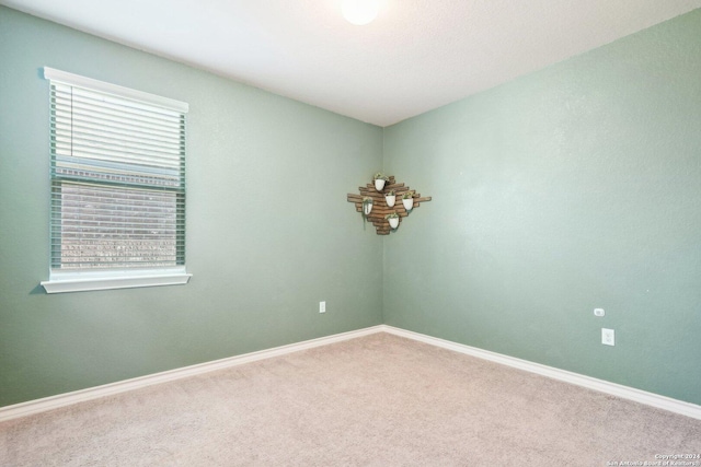 unfurnished room with plenty of natural light and carpet