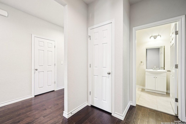 hall featuring dark hardwood / wood-style floors and sink