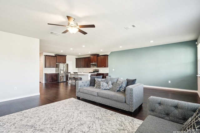 living room with ceiling fan, dark hardwood / wood-style flooring, and sink