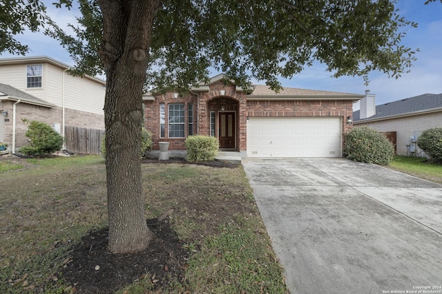 single story home with a front yard and a garage