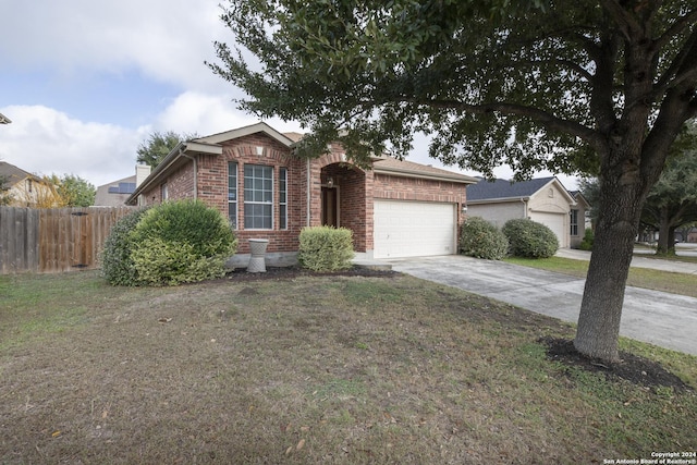 single story home featuring a garage and a front lawn