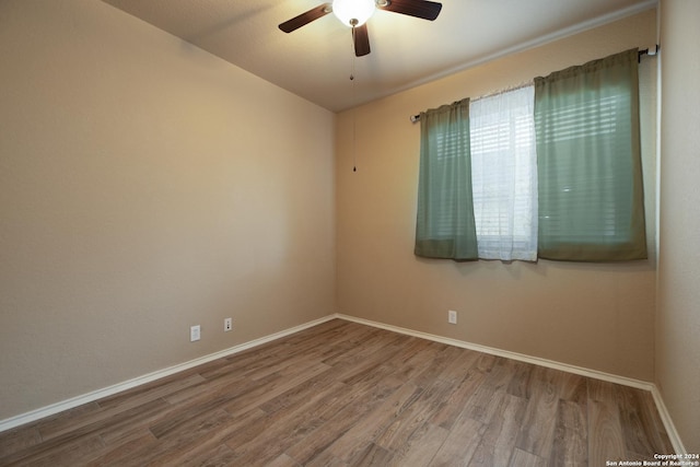 spare room featuring hardwood / wood-style flooring and ceiling fan