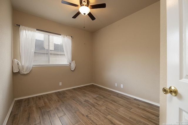 spare room with hardwood / wood-style flooring and ceiling fan