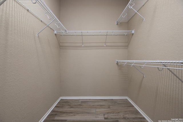 walk in closet featuring hardwood / wood-style flooring