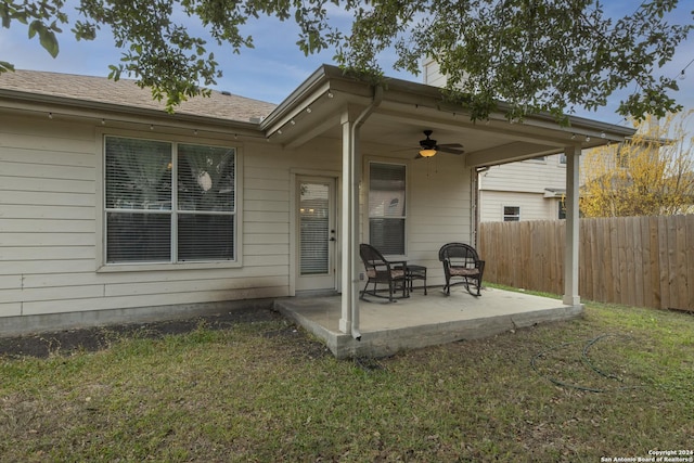 exterior space with a patio area, ceiling fan, and a yard