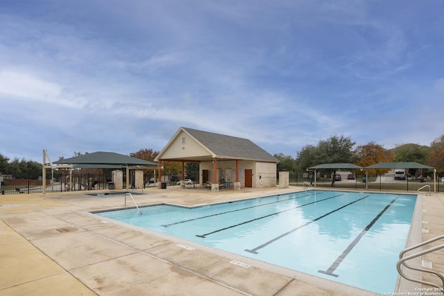 view of pool featuring a patio and an outdoor structure