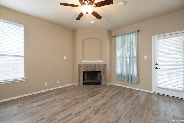 unfurnished living room with ceiling fan and light hardwood / wood-style floors