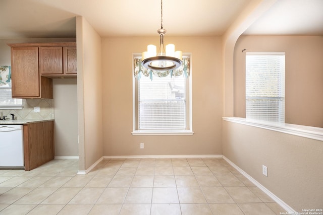 unfurnished dining area featuring light tile patterned floors and a chandelier