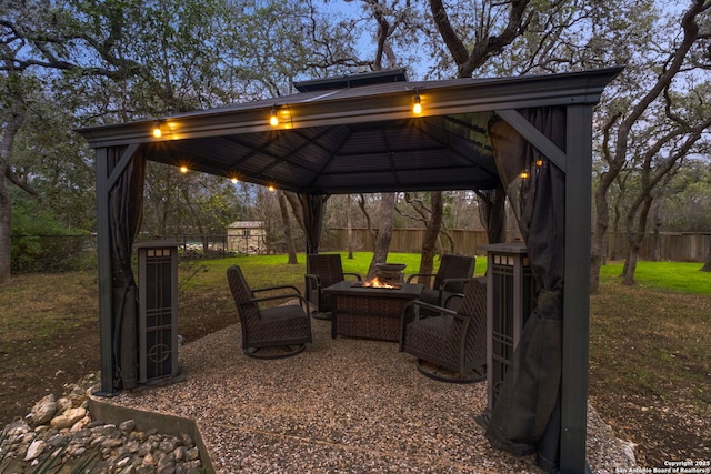 view of patio / terrace with a gazebo and a fire pit