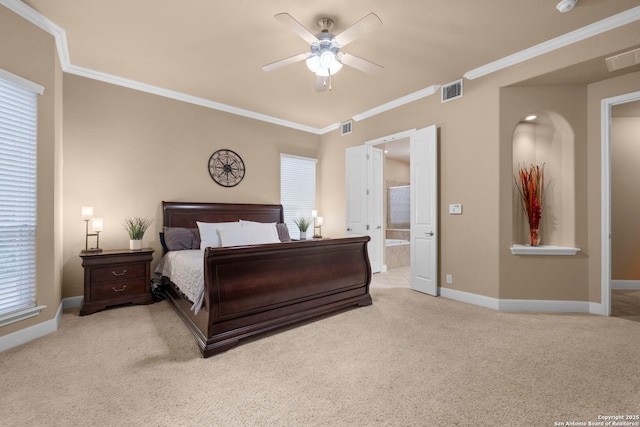 bedroom with ceiling fan, light colored carpet, ornamental molding, and ensuite bath