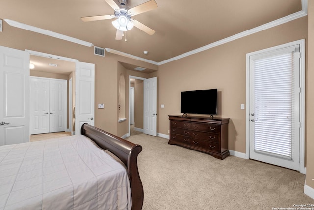 carpeted bedroom with ceiling fan and ornamental molding