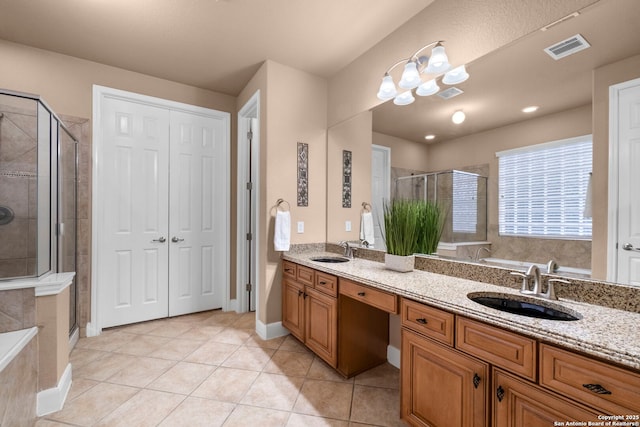 bathroom with plus walk in shower, tile patterned flooring, and vanity