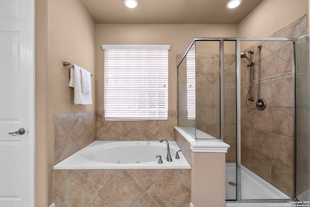 bathroom with shower with separate bathtub and plenty of natural light