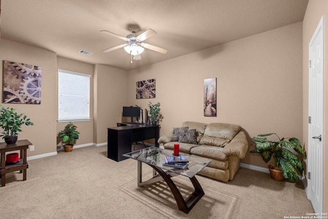 carpeted living room with ceiling fan