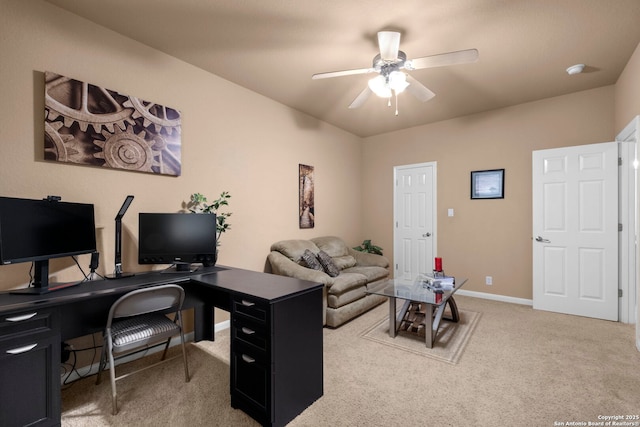 carpeted office space featuring ceiling fan