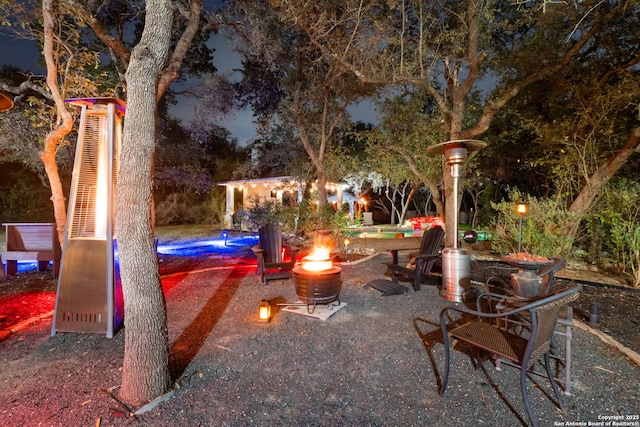 view of patio featuring a fire pit and an outbuilding