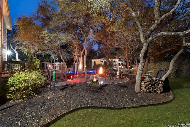 yard at twilight featuring a playground