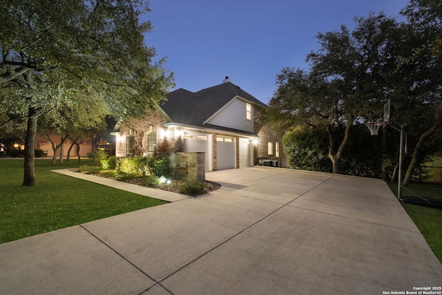 view of front of property with a garage and a yard