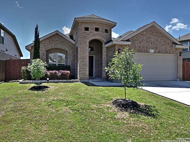 view of front facade with a garage and a front yard