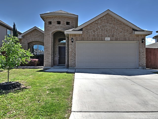 view of front of house with a front lawn and a garage