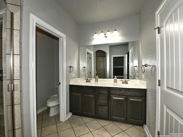 bathroom featuring tile patterned flooring, vanity, and toilet