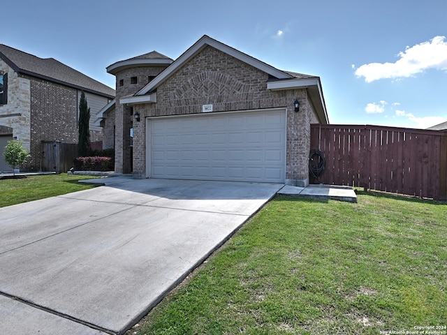 view of front of house with a garage and a front lawn