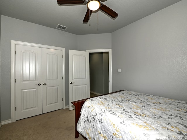 carpeted bedroom with a closet and ceiling fan