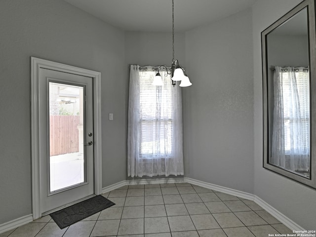 interior space featuring a notable chandelier and light tile patterned floors