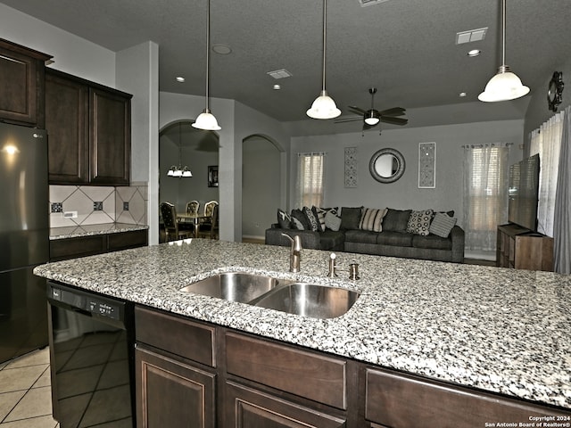 kitchen with dishwasher, light stone countertops, fridge, and sink