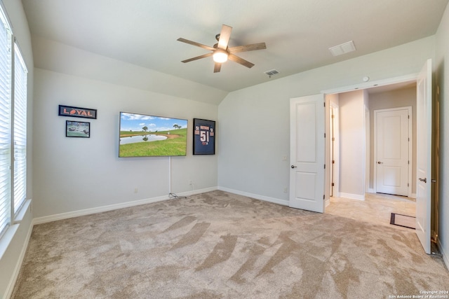 empty room with ceiling fan, light carpet, and lofted ceiling