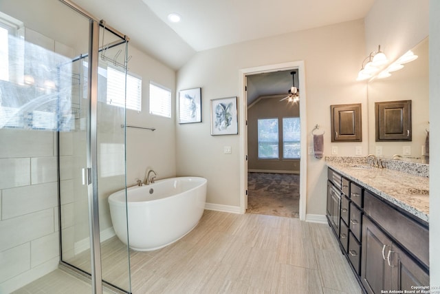 bathroom featuring separate shower and tub, vanity, a healthy amount of sunlight, and lofted ceiling