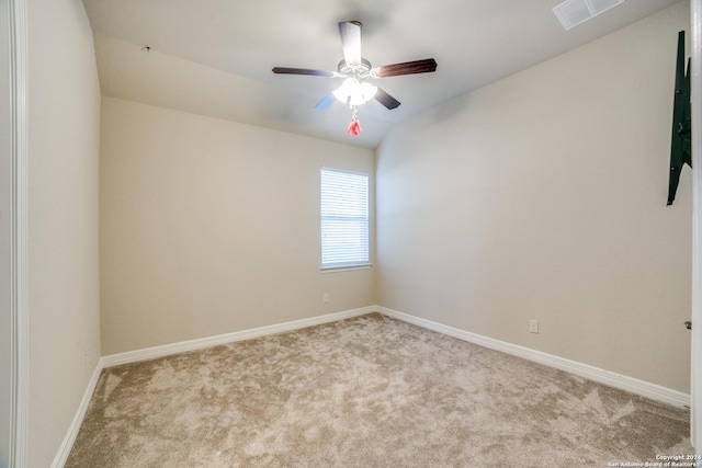 carpeted spare room with ceiling fan and vaulted ceiling