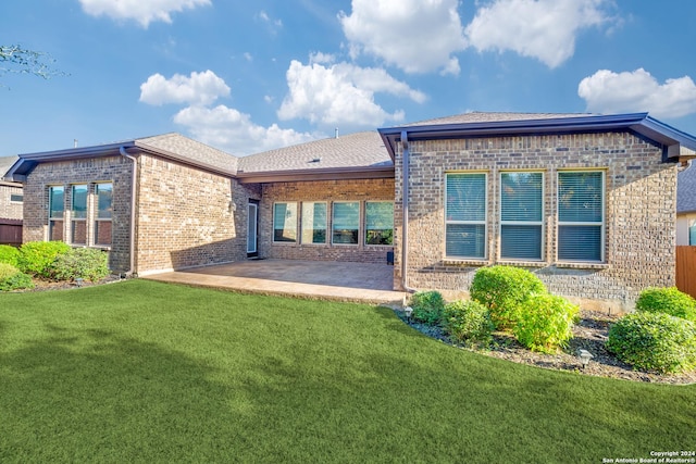 rear view of property featuring a yard and a patio