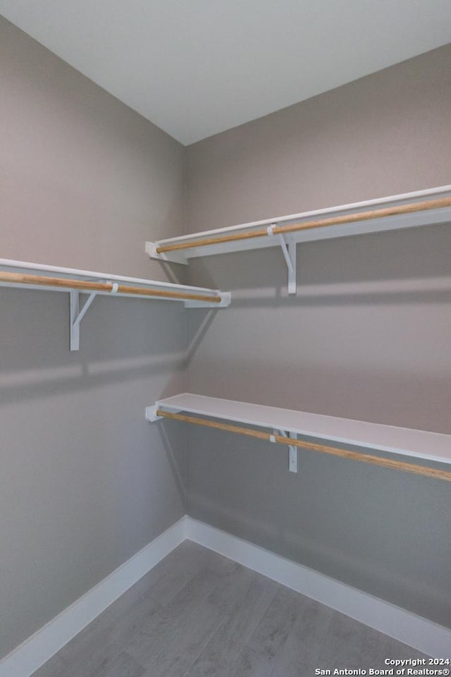 walk in closet featuring hardwood / wood-style flooring