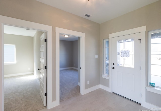 view of carpeted entrance foyer