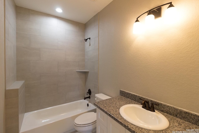 full bathroom with vanity, toilet, and tiled shower / bath combo