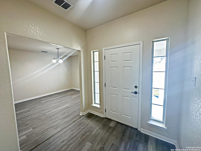 foyer featuring a chandelier and dark hardwood / wood-style floors