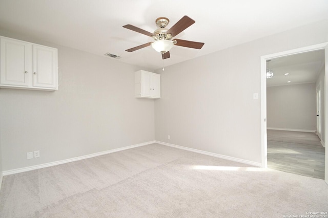 empty room with light carpet and ceiling fan